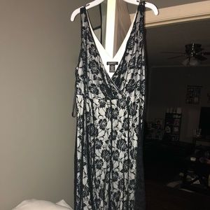 Sleeveless black lace dress with white underneath